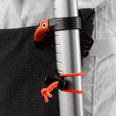Close up view of the reflective bungees holding an Ice Axe tool on the Hyperlite Mountain Gear Crux 40