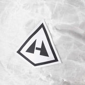 Detail shot of the Hyperlite Mountain Gear Logo on the front of the Southwest 70 Pack in White