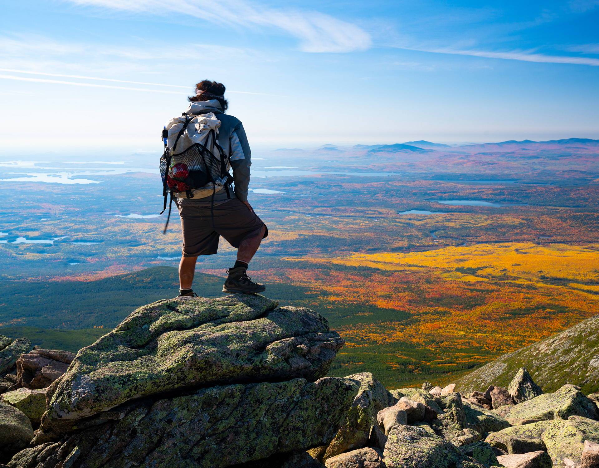 A man standing on top of a rock.